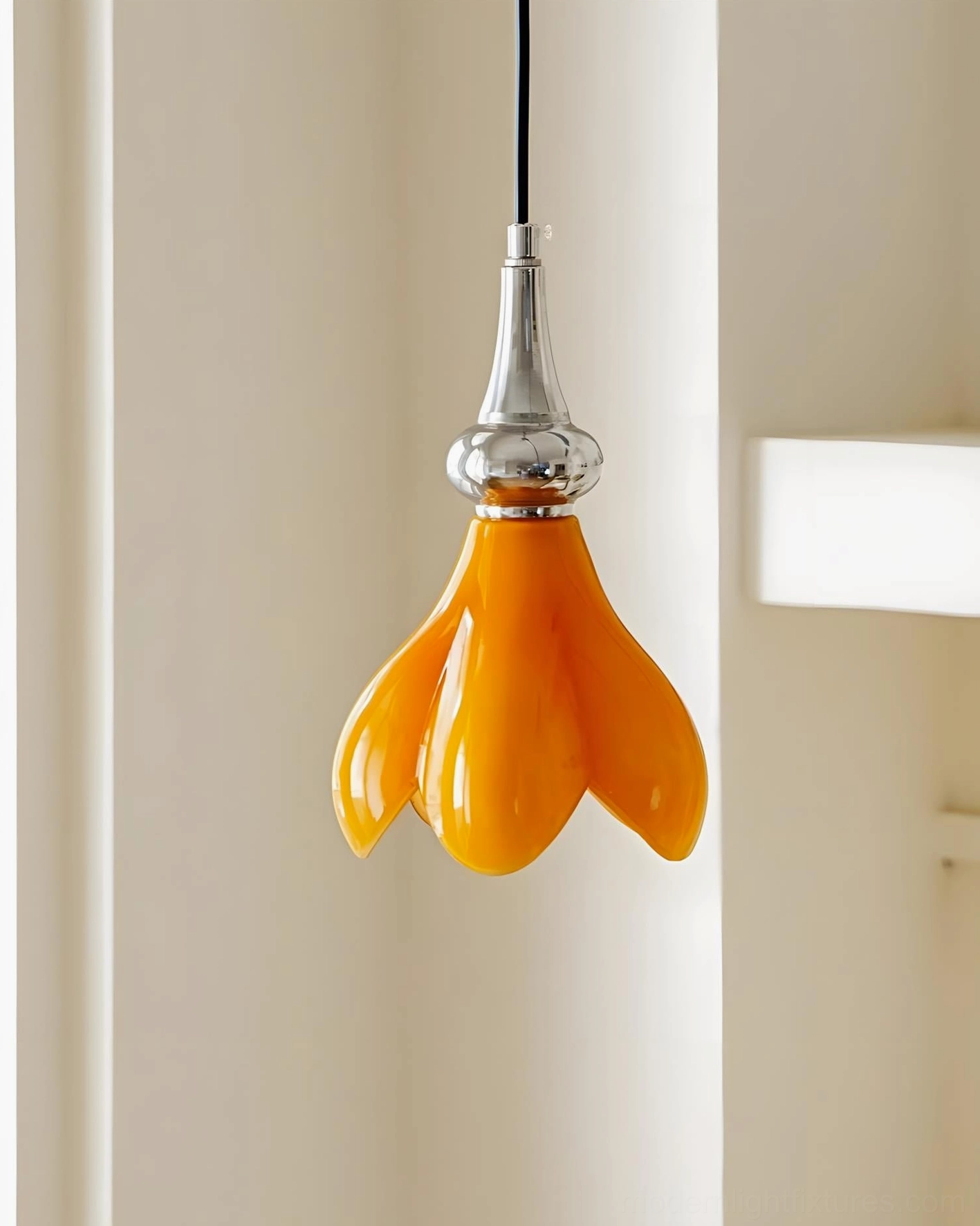 Saffron flower pendant light side close-up showing design details, orange glass sculpted shade with chrome metal connector