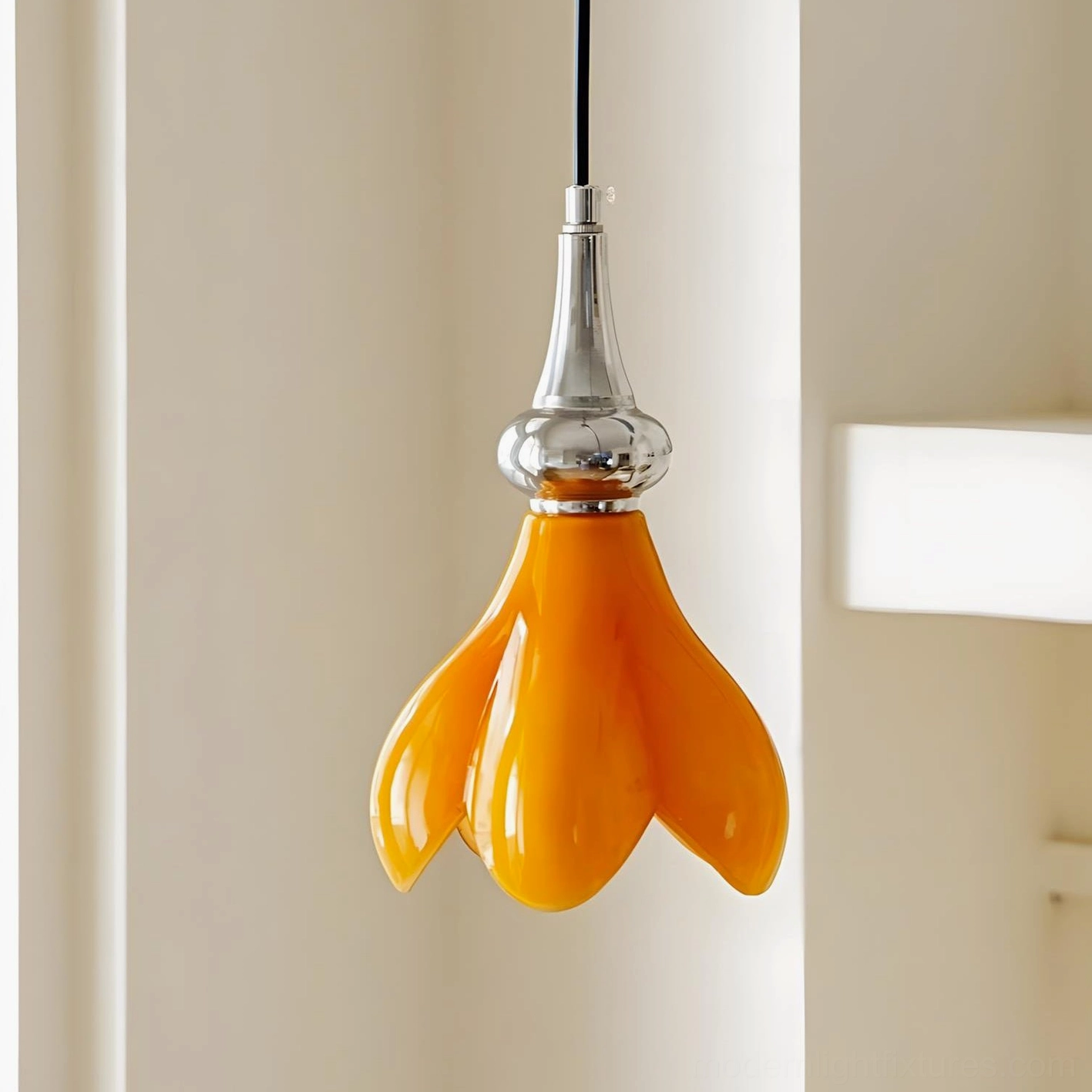 Side view of retro saffron pendant lamp showing glossy orange glass shade with polished chrome metal base and hanging wire