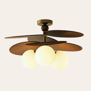 Three-head Salisbury ceiling light fixture angled view, showing overlapping leaf-blade design with warm gold brass accents and frosted white glass spheres