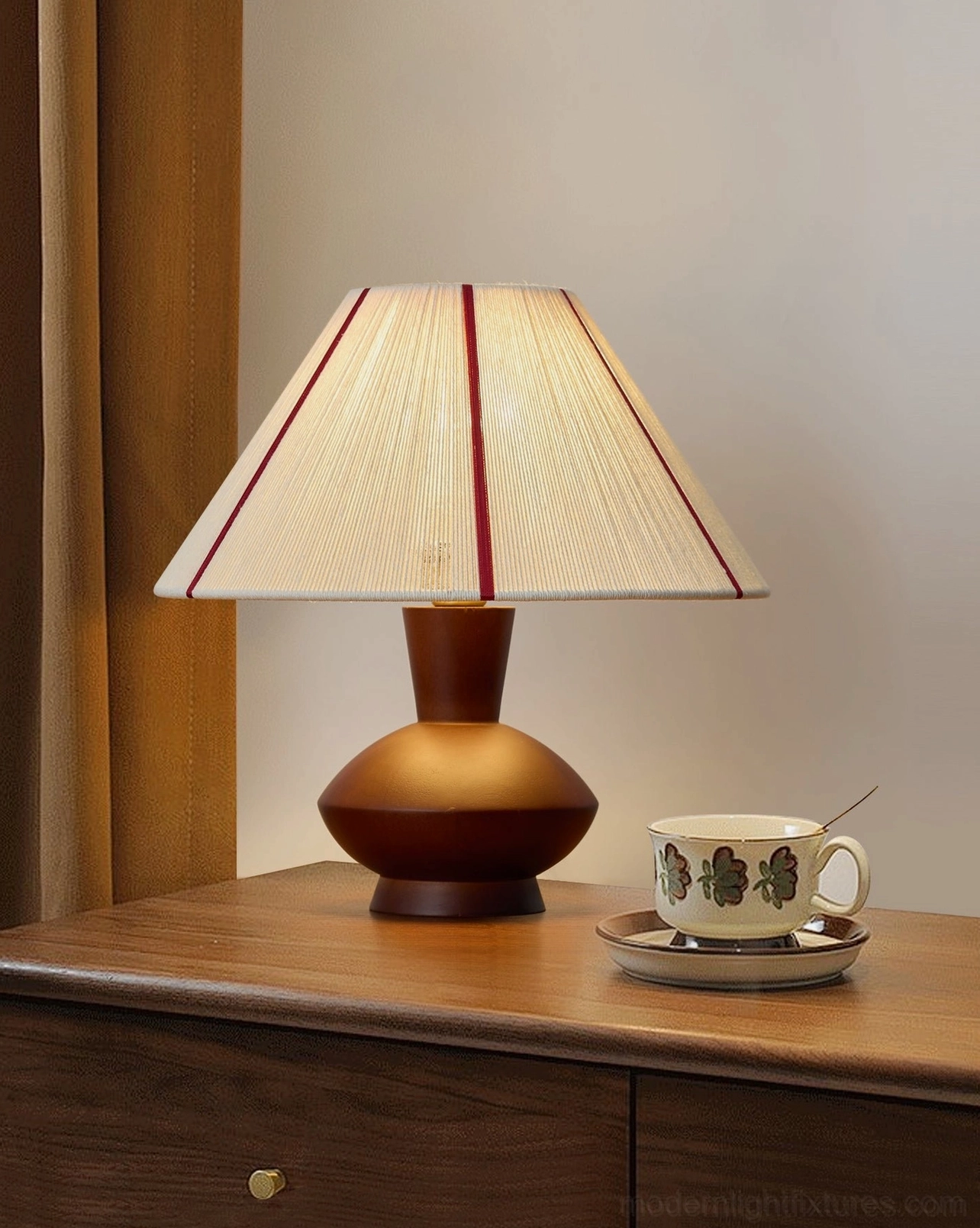 Sandia mid-century modern table lamp on dark wood bedroom dresser with ceramic accessories, three-quarter angle view, warm vintage interior aesthetic
