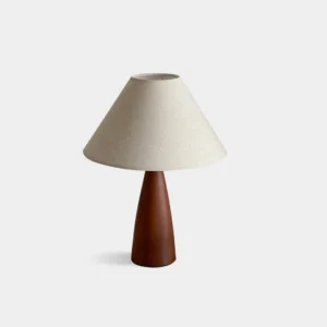 Sandstone table lamp with tapered linen shade, front flat view on white background, modern minimalist design