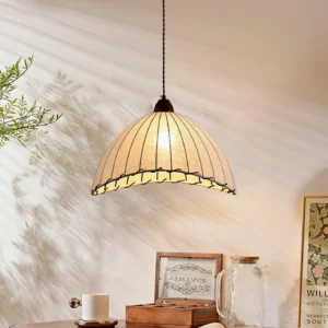 Sanna pendant light hanging at three-quarter angle creating ribbed texture shadow on wall