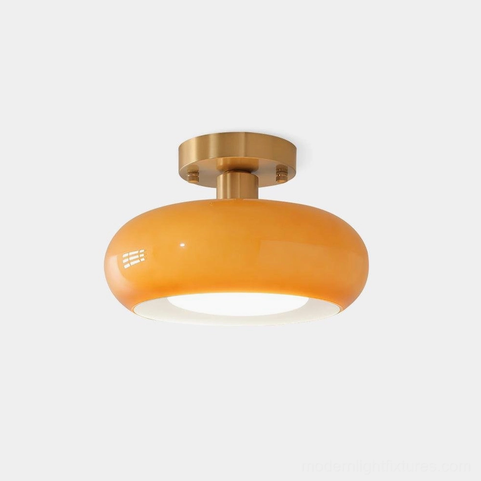 Sanna modern glass ceiling light with brass gold canopy and warm amber glass dome - product front view