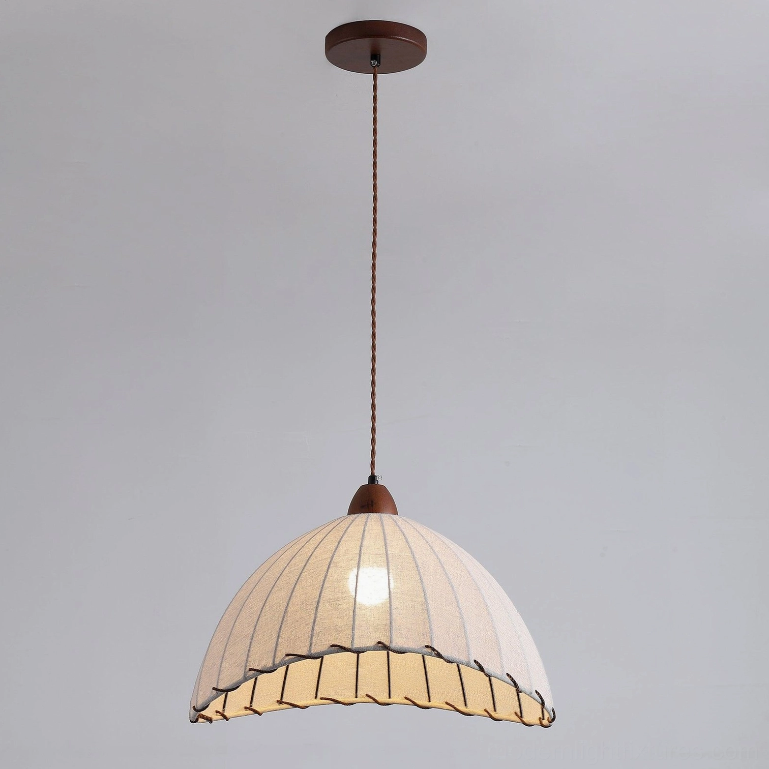 Sanna pendant lamp installation view showing wire adjustment and ceiling mount