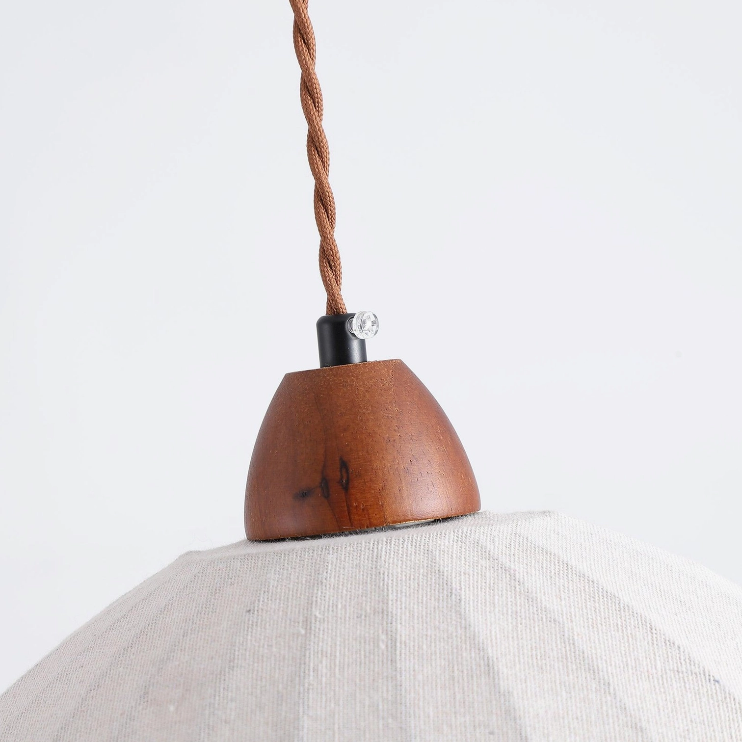 Sanna fabric pendant lamp overhead installation showing walnut canopy and wire length