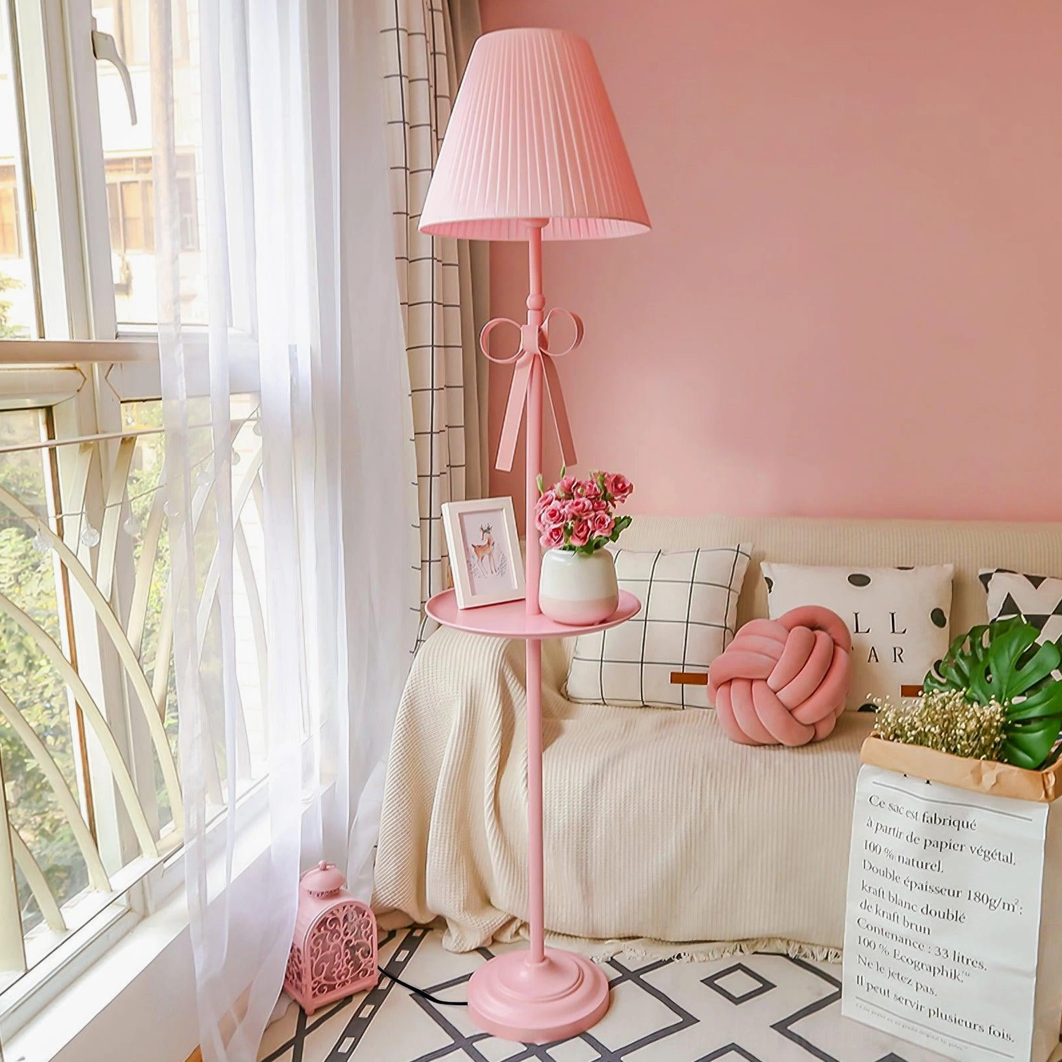 Pink pleated ribbon floor lamp with side shelf in balcony lounge setting