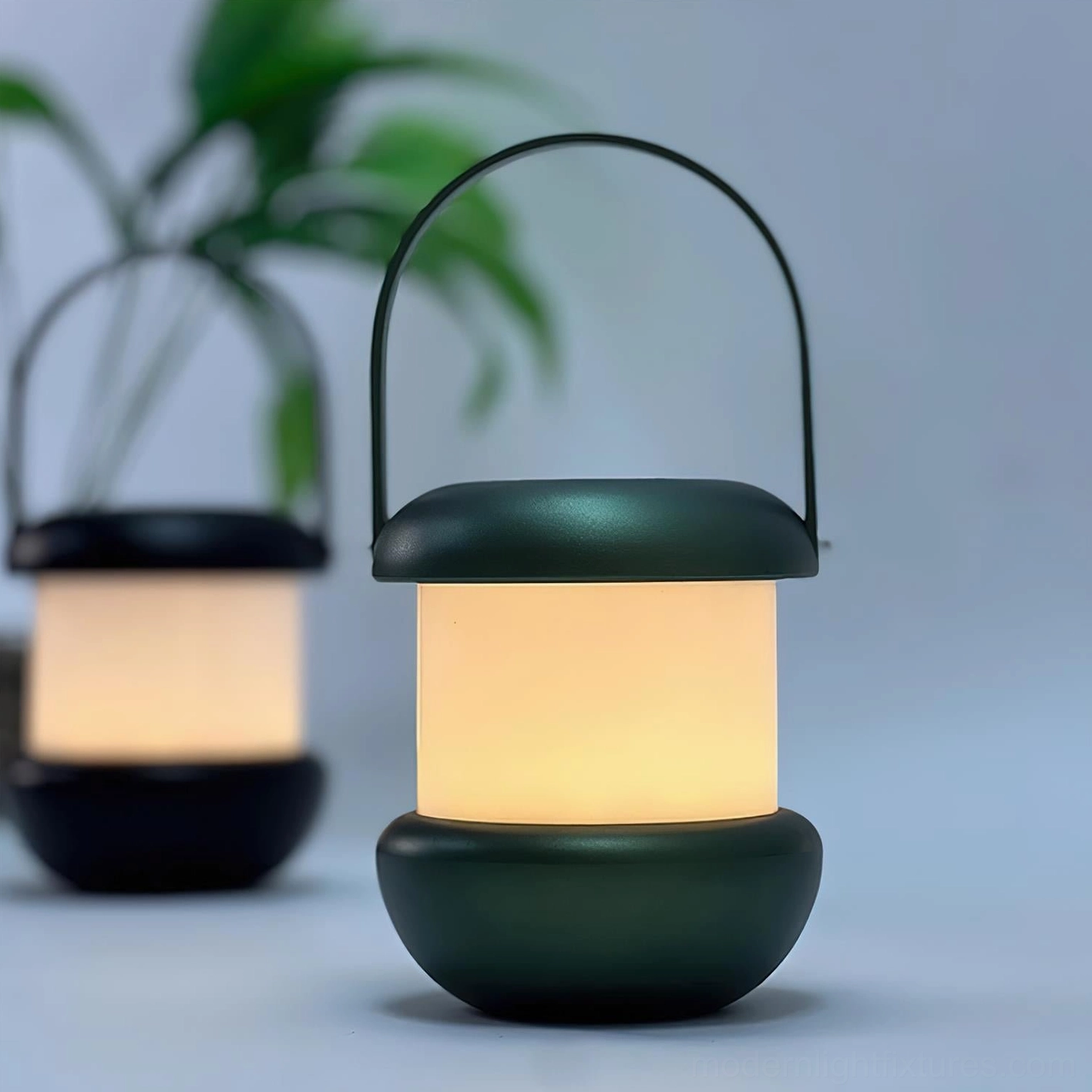 Sarina rechargeable LED portable lanterns in black and deep green with curved handles - close-up studio view