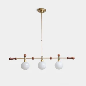Satilla 3-head linear globe chandelier in brass gold finish with frosted milk-white glass shades, studio product view