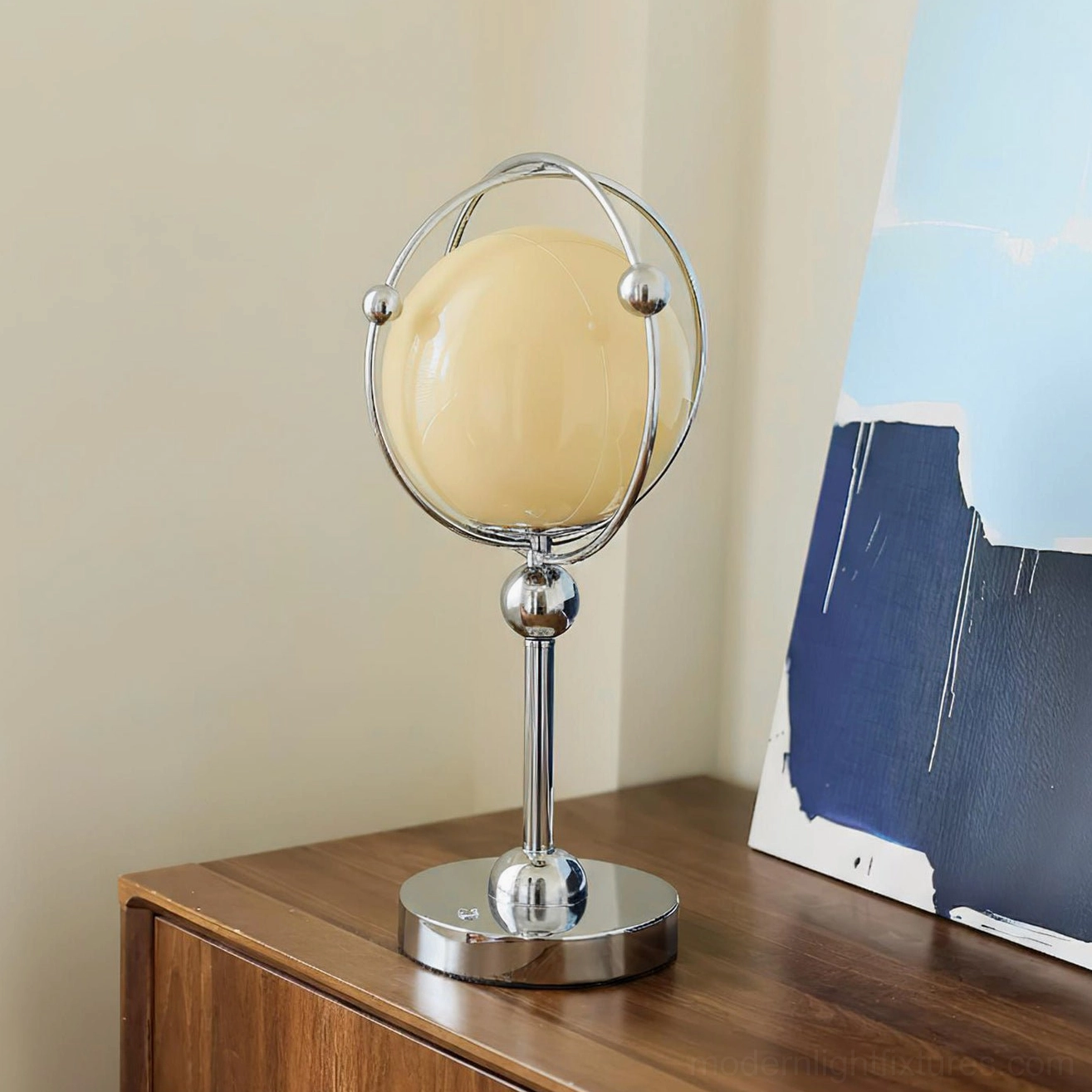 Saturn Hoop Table Lamp displayed on wooden side table with abstract wall art - contemporary interior styling
