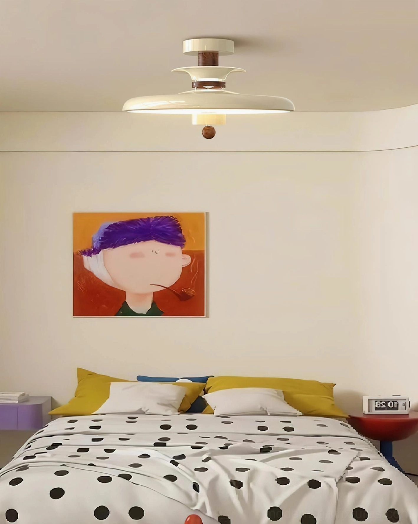 Saturn Pop geometric fixture mounted on ceiling with beige and brown neutral tones polka dot bedding