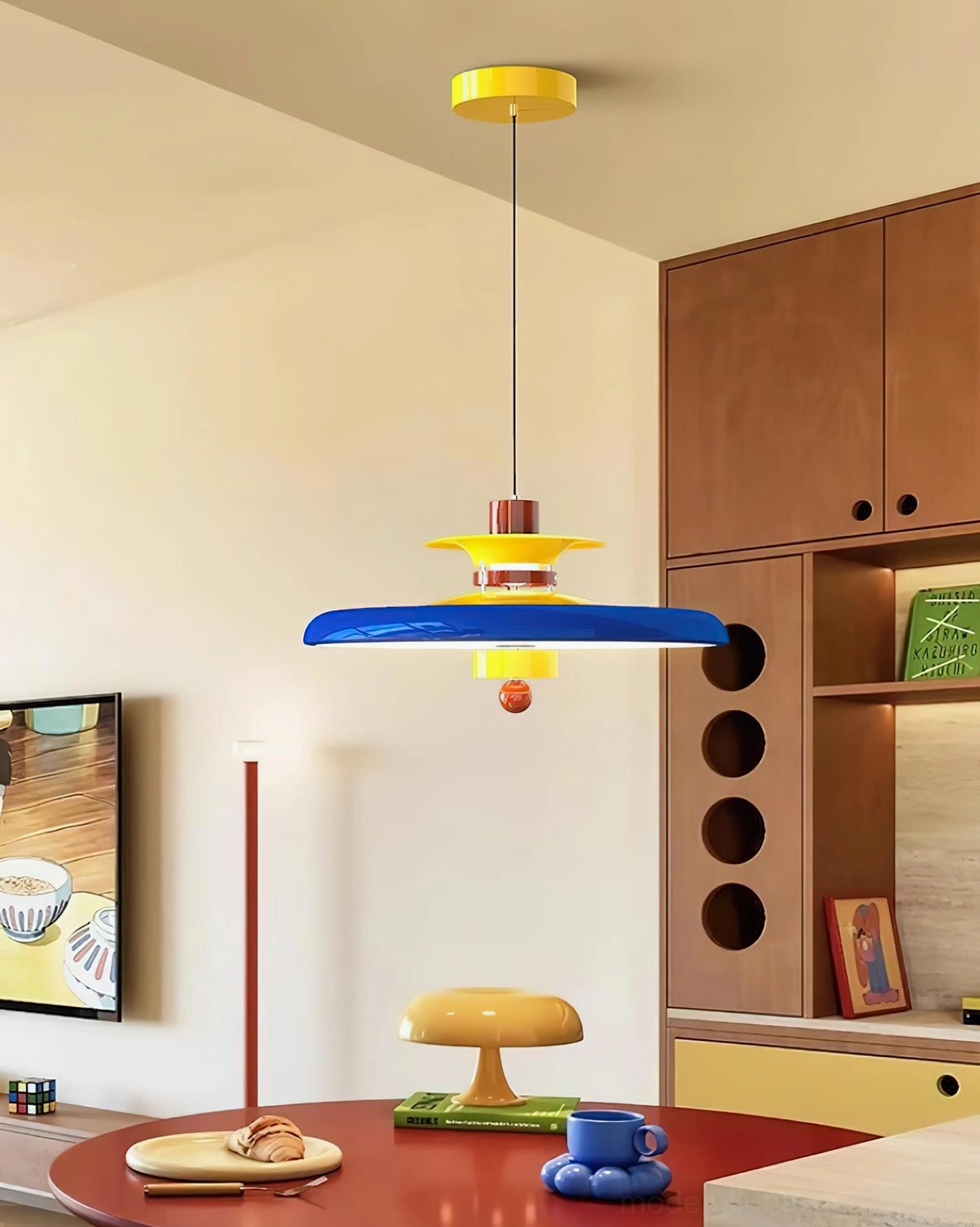 Saturn Pop pendant light installed in residential dining area with blue, yellow and brown color palette