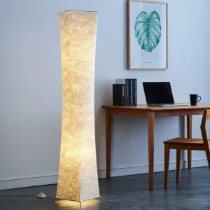 Saura minimalist floor lamp in home office workspace with warm ambient glow and neutral modern decor