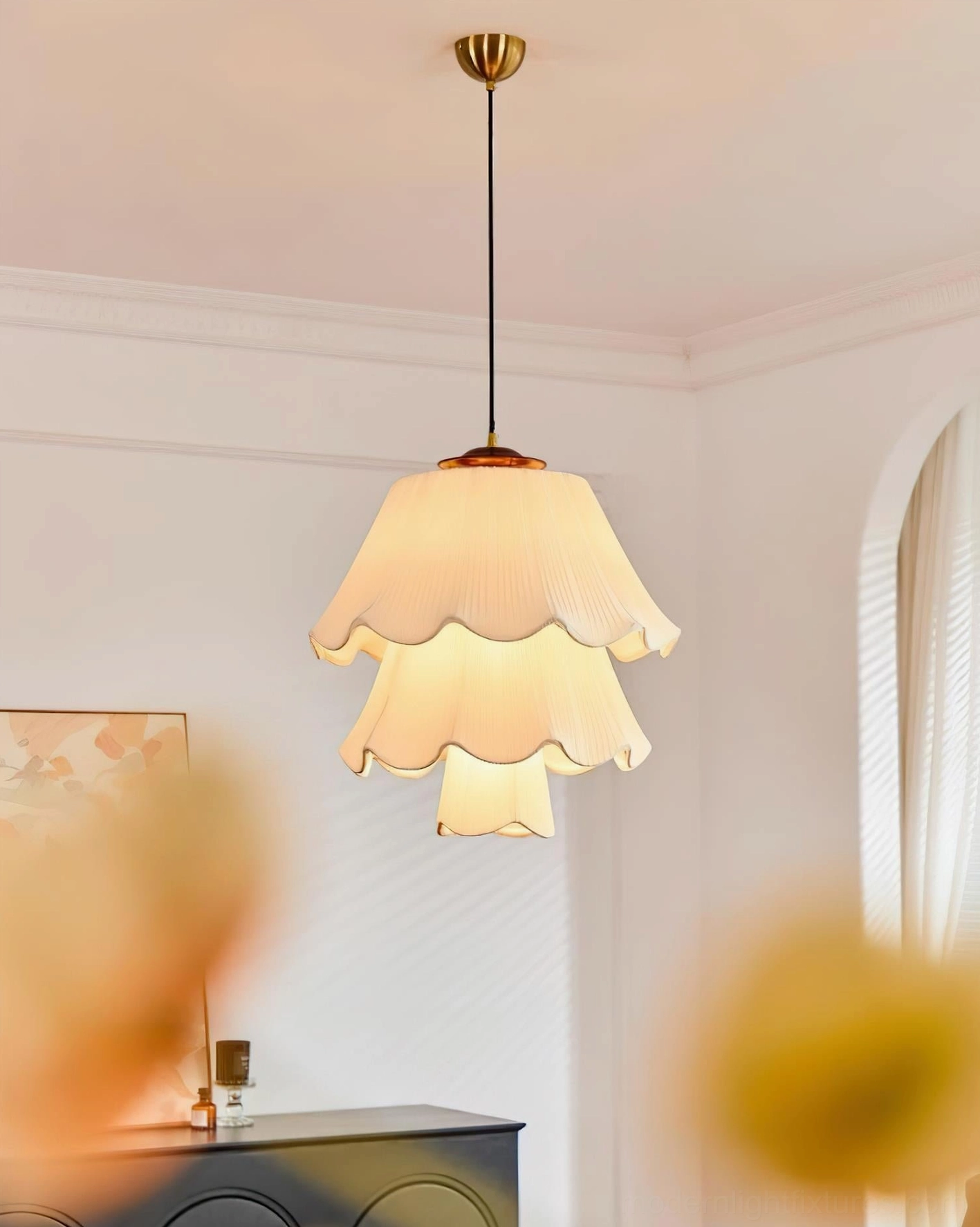 Savena two-tier pleated pendant lamp with layered cream fabric shade suspended in vintage-inspired living room with dark sideboard