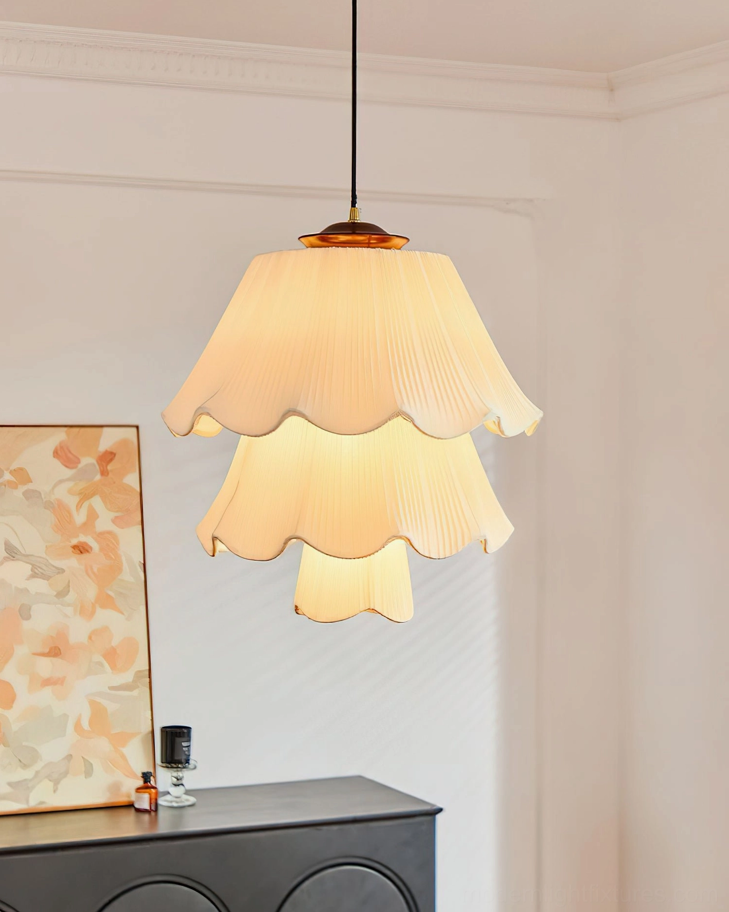 Savena vintage pendant lamp with layered pleated fabric shade suspended in modern living room with dark furniture and artwork