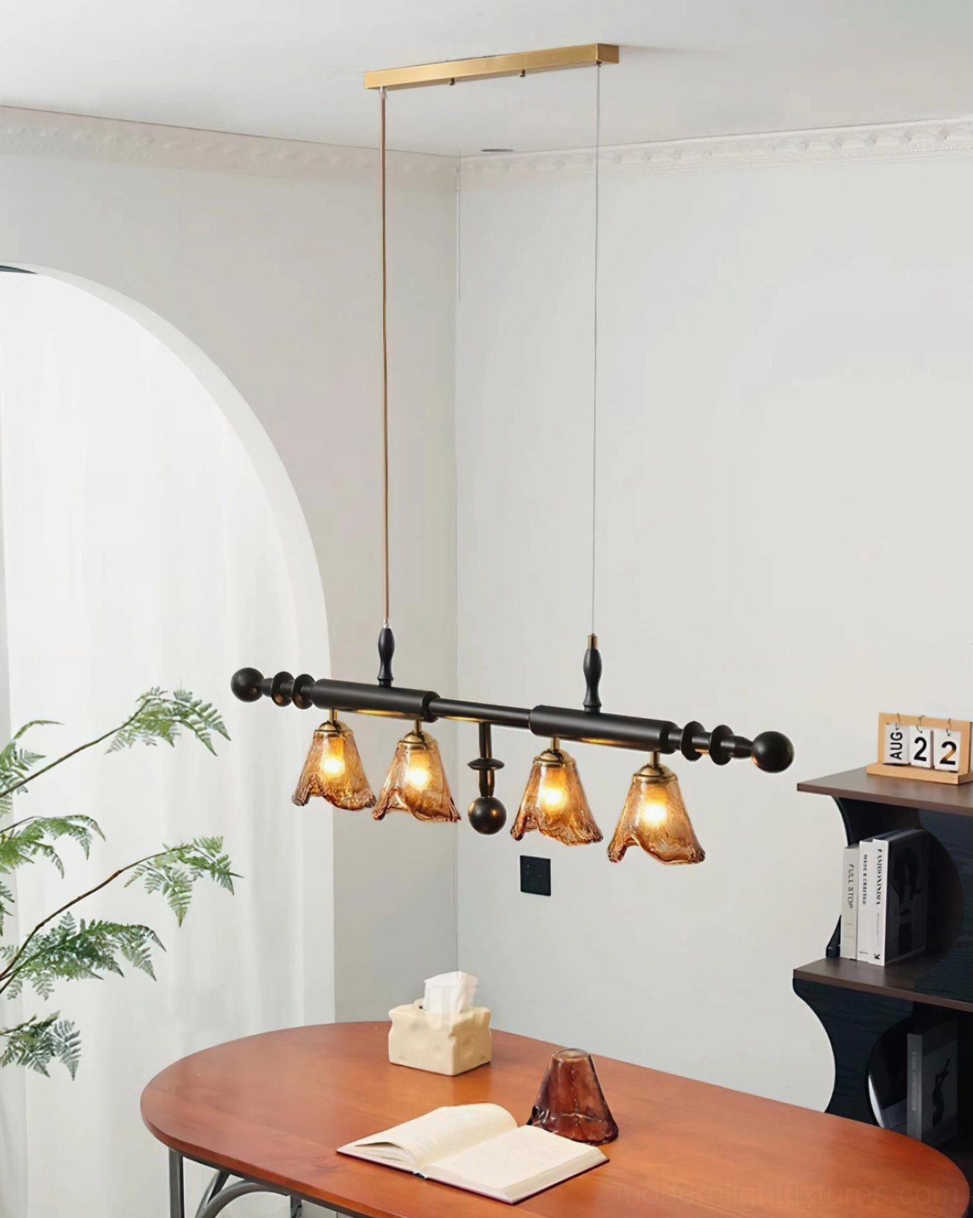 Savoy 4-light dining pendant chandelier front view in cozy home dining nook with brass ceiling rod and amber rippled glass