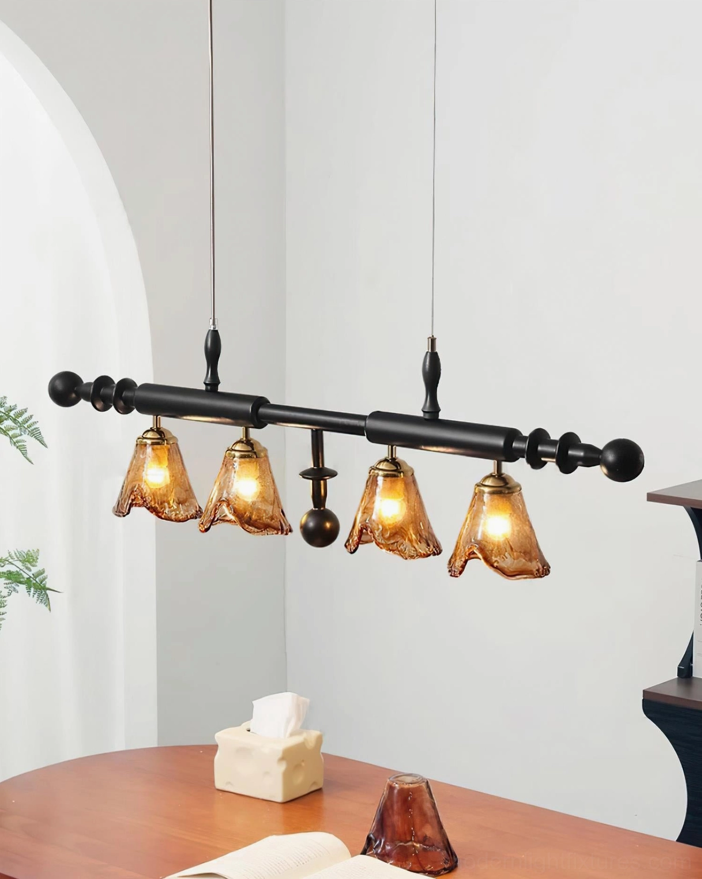 Savoy 4-light dining pendant light side view with black metal frame and dual hanging wires above wooden dining table