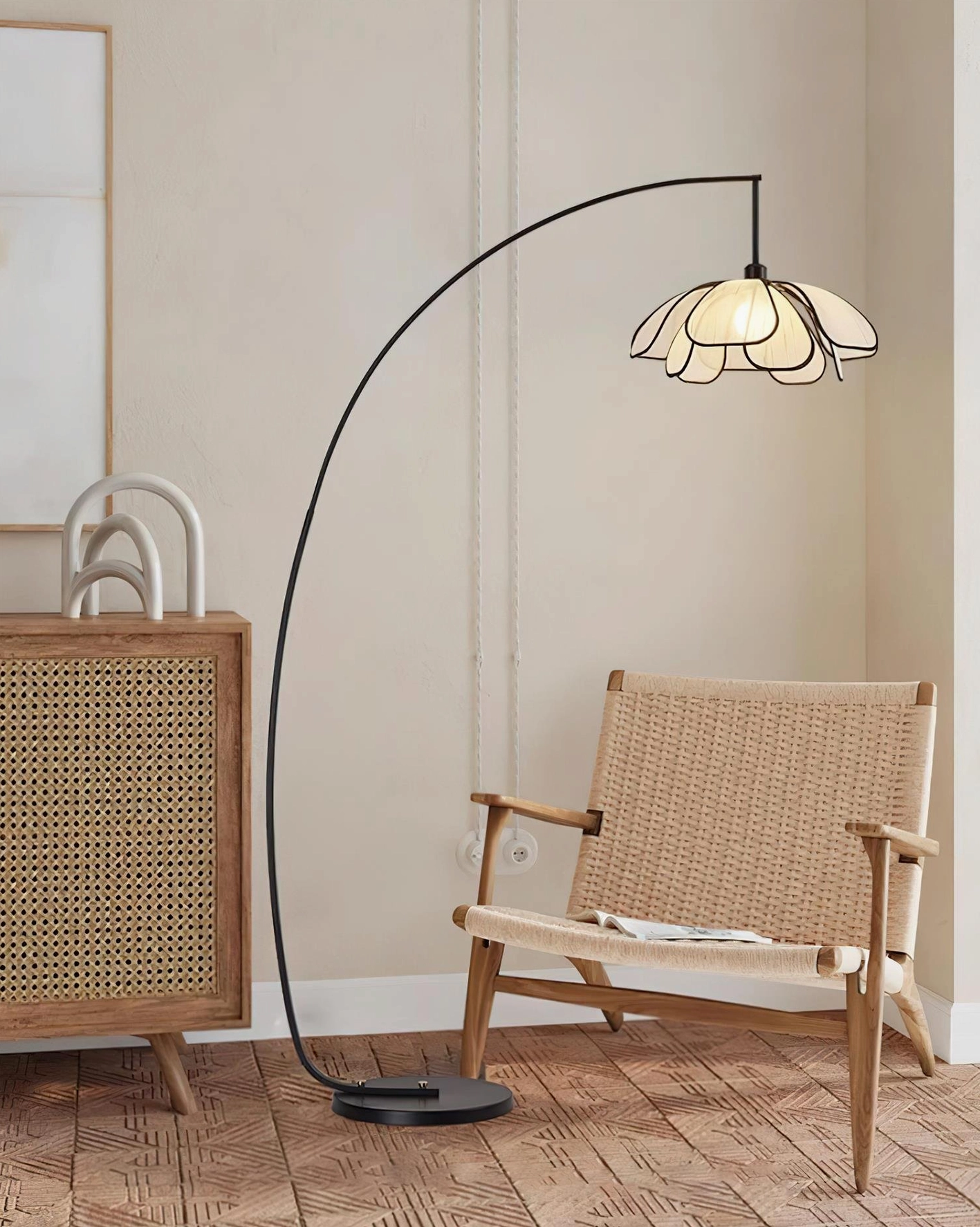 Savoy arc floor lamp in Scandinavian modern bedroom setting with rattan chair and minimalist wall artwork