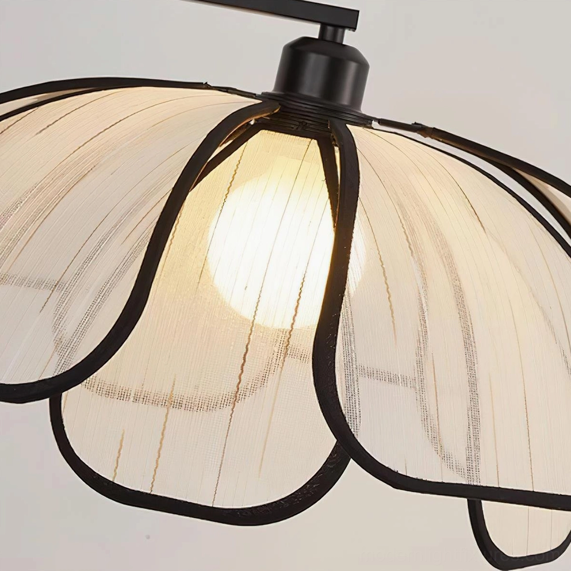 Close-up detail of Savoy floor lamp fabric shade, black petal-shaped metal frame with sheer light-diffusing textile
