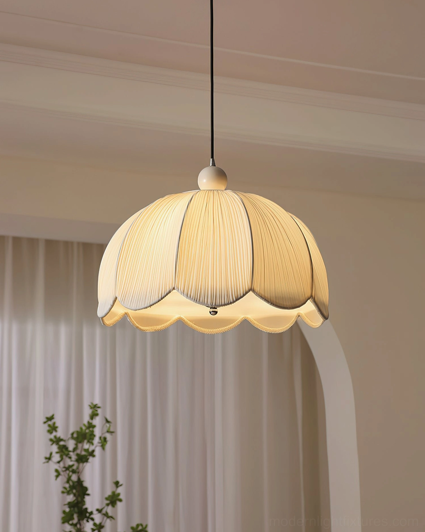 Scalloped pleated pendant light glowing warm yellow, casual dining nook intimate ambiance, petal-shaped fabric shade