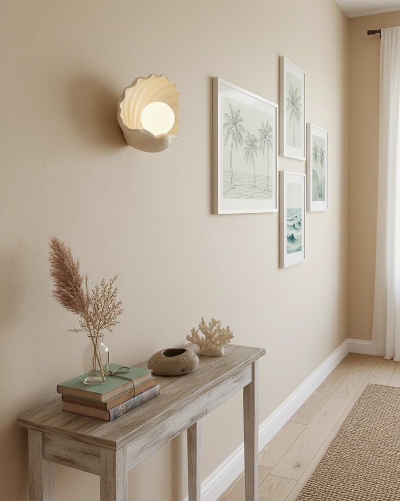 Scallop shell wall lamp in residential hallway gallery, coastal art prints and console table, interior ambient lighting fixture