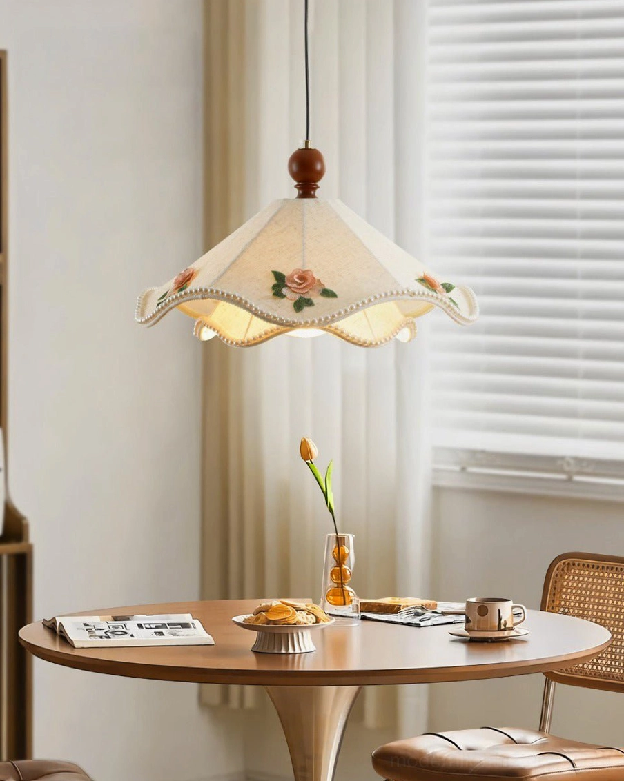 Scalloped fabric pendant light with linen shade and embroidered roses, soft warm glow through fabric