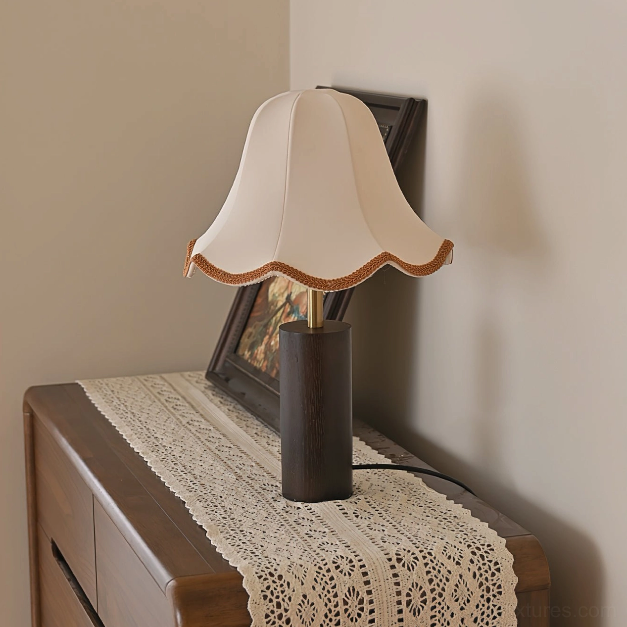 Scalloped fabric lampshade with brass trim edge detail on table lamp showing textile construction