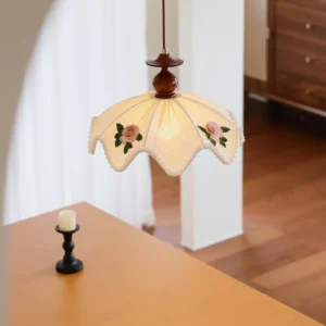 Vintage scalloped pendant lamp overhead close-up showing hand-embroidered floral accents and beaded trim
