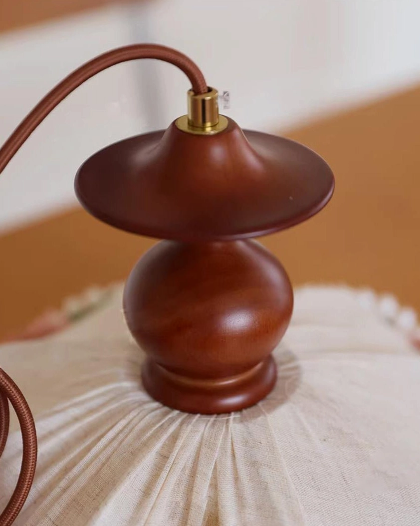Walnut wood fixture top of scalloped pendant lamp with metal hardware detail