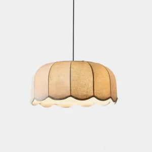 Scalloped fabric pendant light with segmented beige linen shade and wavy lower rim, direct front view in studio lighting