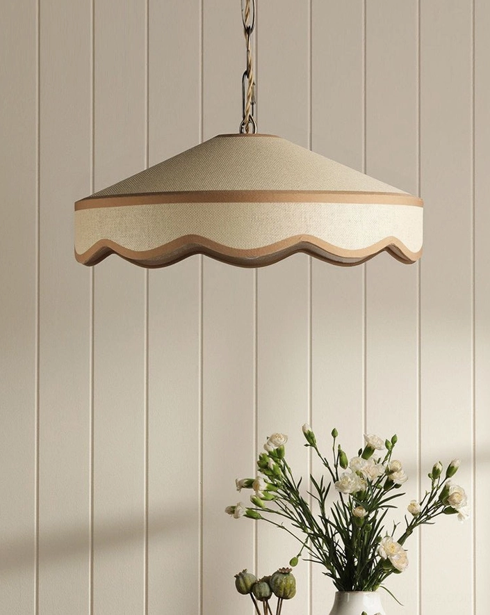 Brass-tone adjustable chain on scalloped pendant light showing suspension hardware and metal canopy