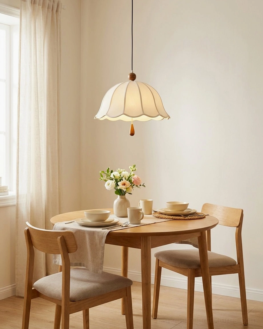 Cotton-linen scalloped dome pendant in casual dining space with warm neutral palette and intimate table setting