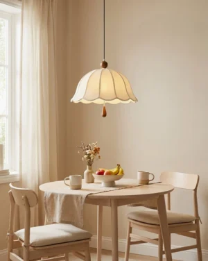 Scalloped fabric pendant light hanging in cozy farmhouse dining nook with natural wood table and vintage rustic decor