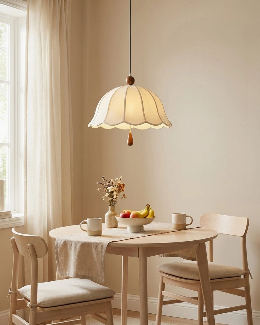 Scalloped fabric pendant light hanging in cozy farmhouse dining nook with natural wood table and vintage rustic decor