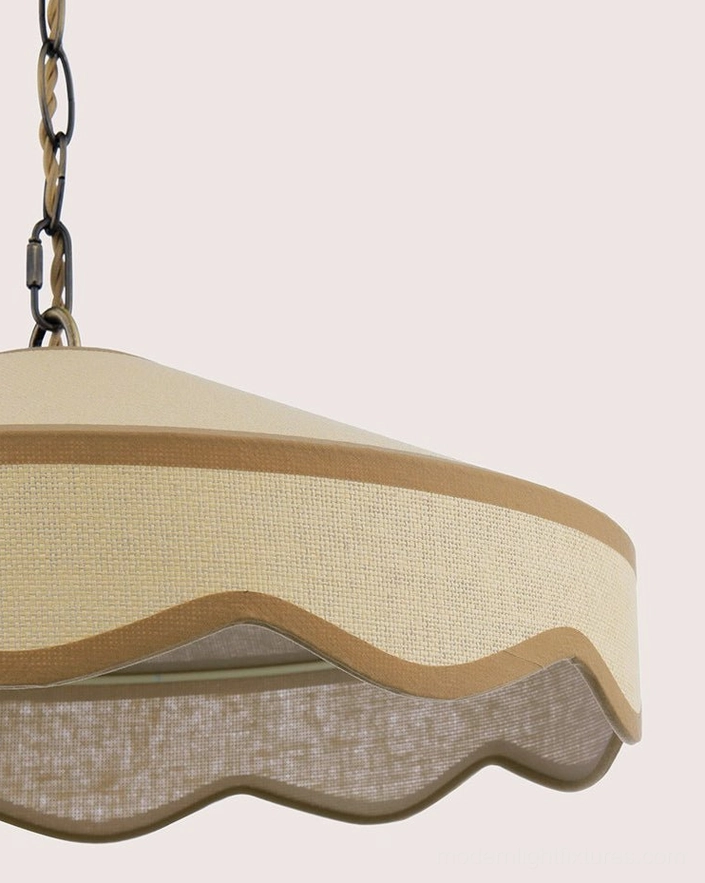 Overhead view of scalloped fabric pendant light showing coolie shade profile and light distribution pattern