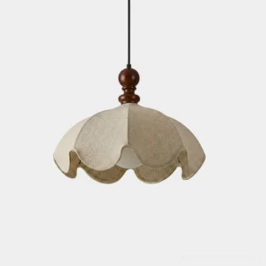 Scalloped petal pendant light with walnut wood finial and cream beige fabric shade front view studio
