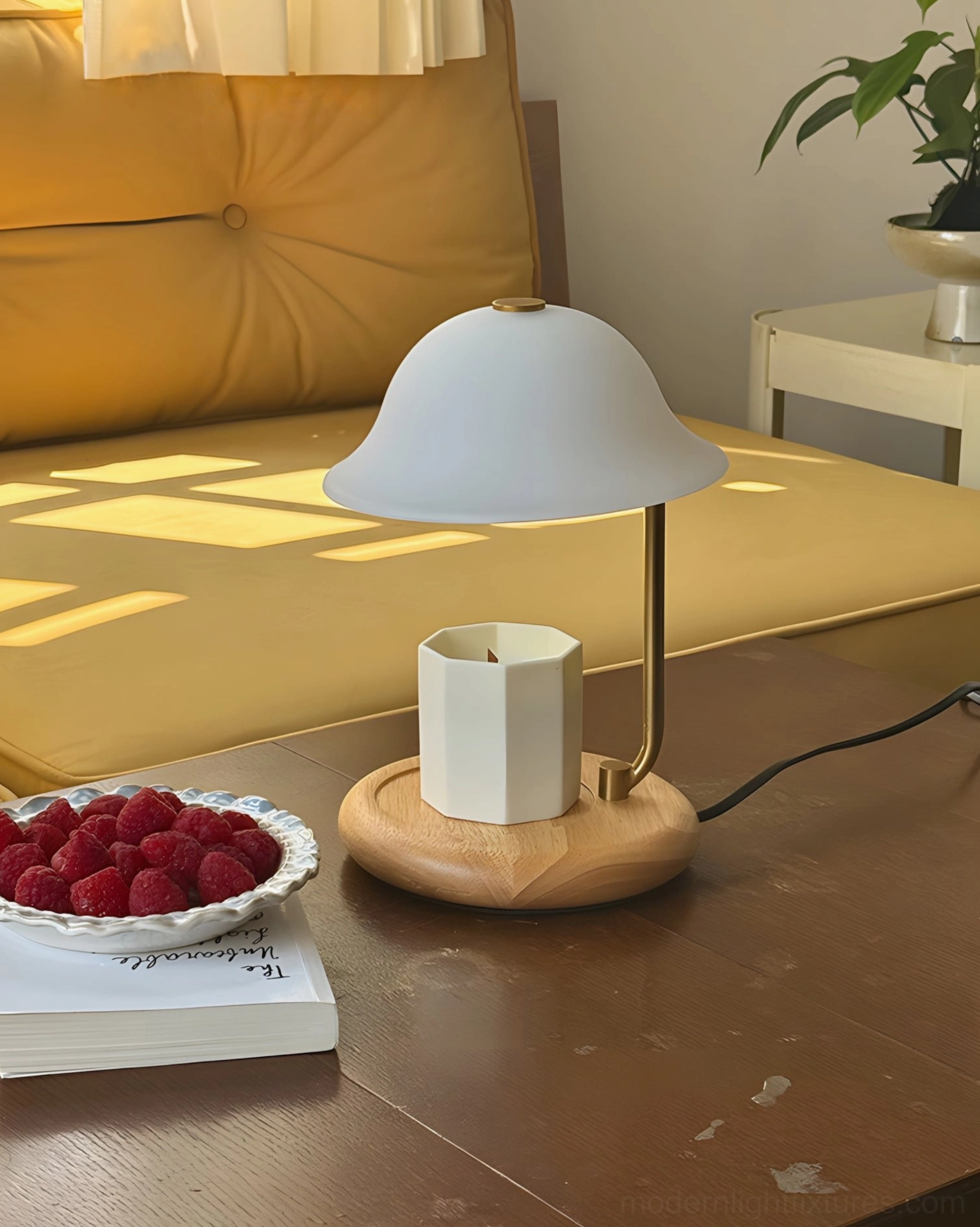 Nordic design candle warmer table lamp with light wood base on yellow tufted sofa table