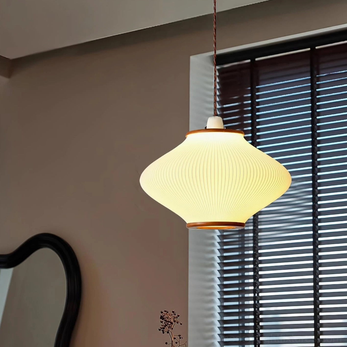 Japanese-inspired pendant fixture with wood accents shown in Scandinavian-style interior setting