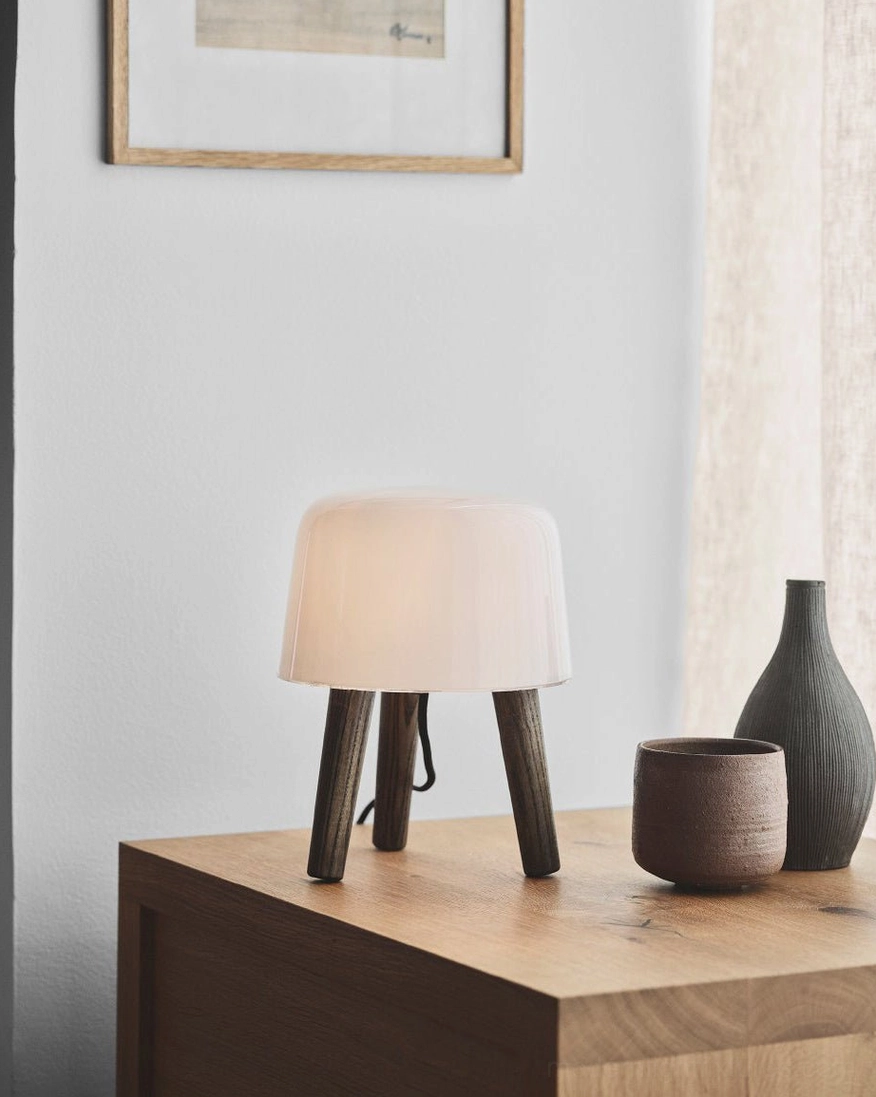 Modern milk glass table lamp with natural wood base in Scandinavian minimalist style, perfect for contemporary home lighting