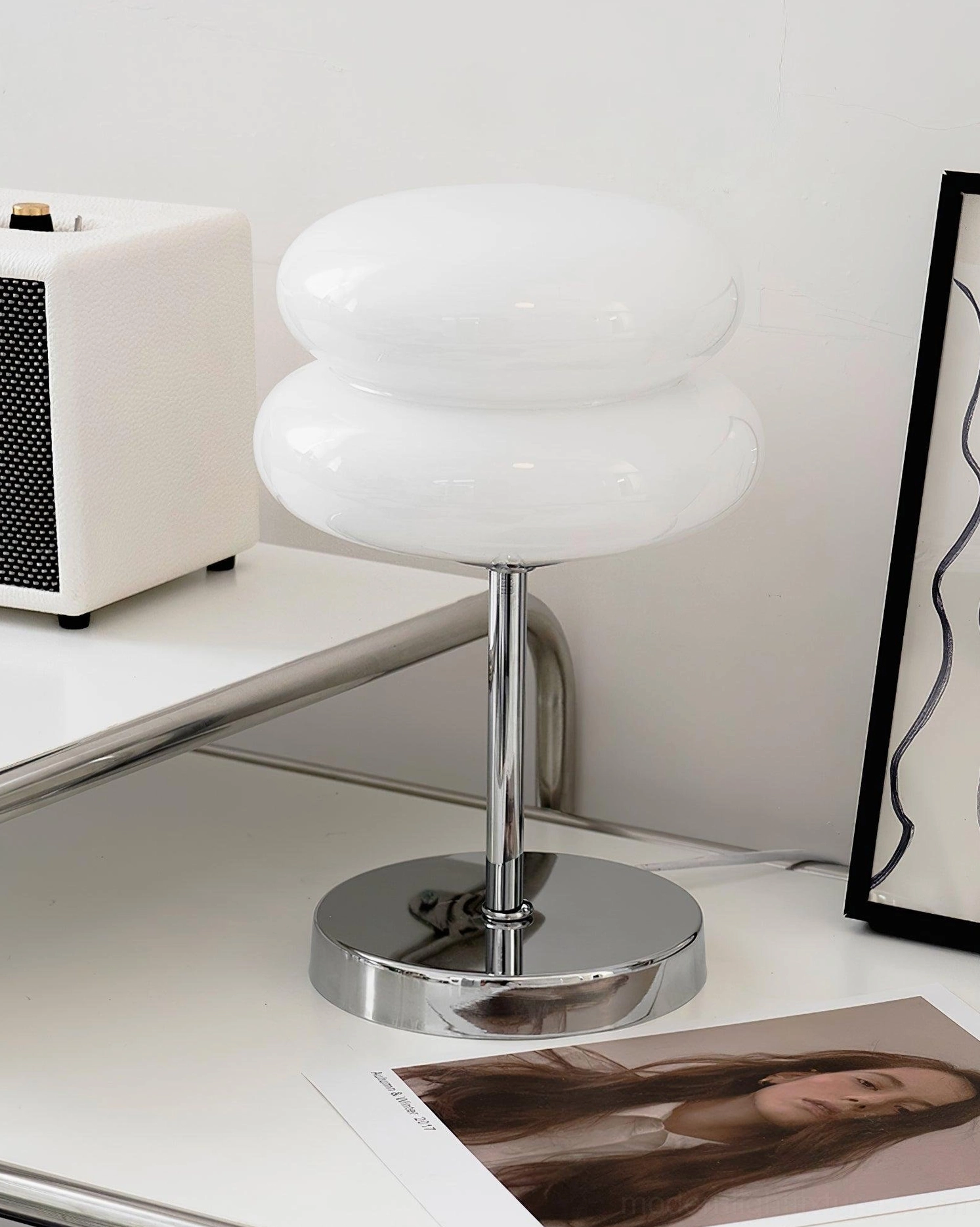 Contemporary glass table lamp styled in Scandinavian minimalist interior design setting