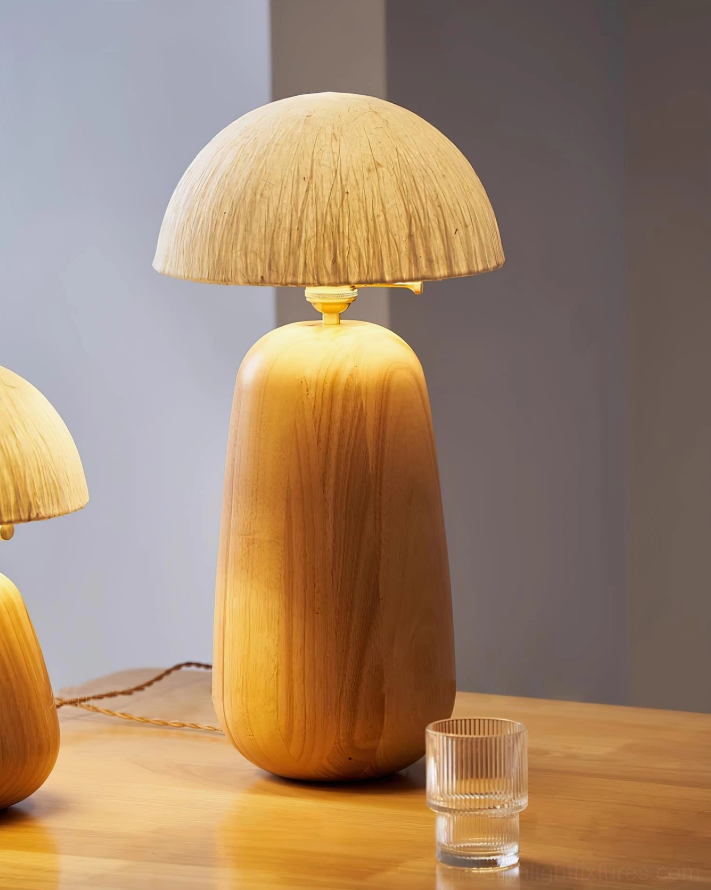 Minimalist oak wood table lamp with rice paper shade creating soft diffused light in scandinavian interior