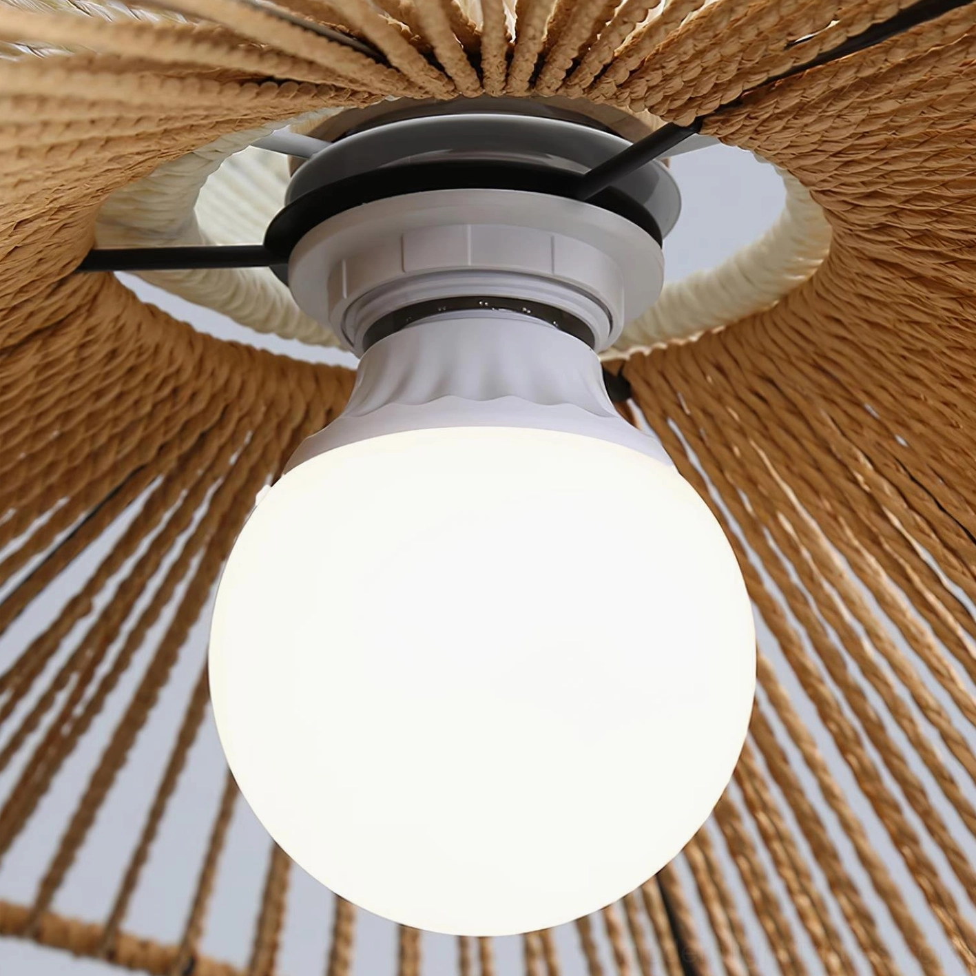 White and brown tone handwoven rattan pendant light in Scandinavian interior design setting