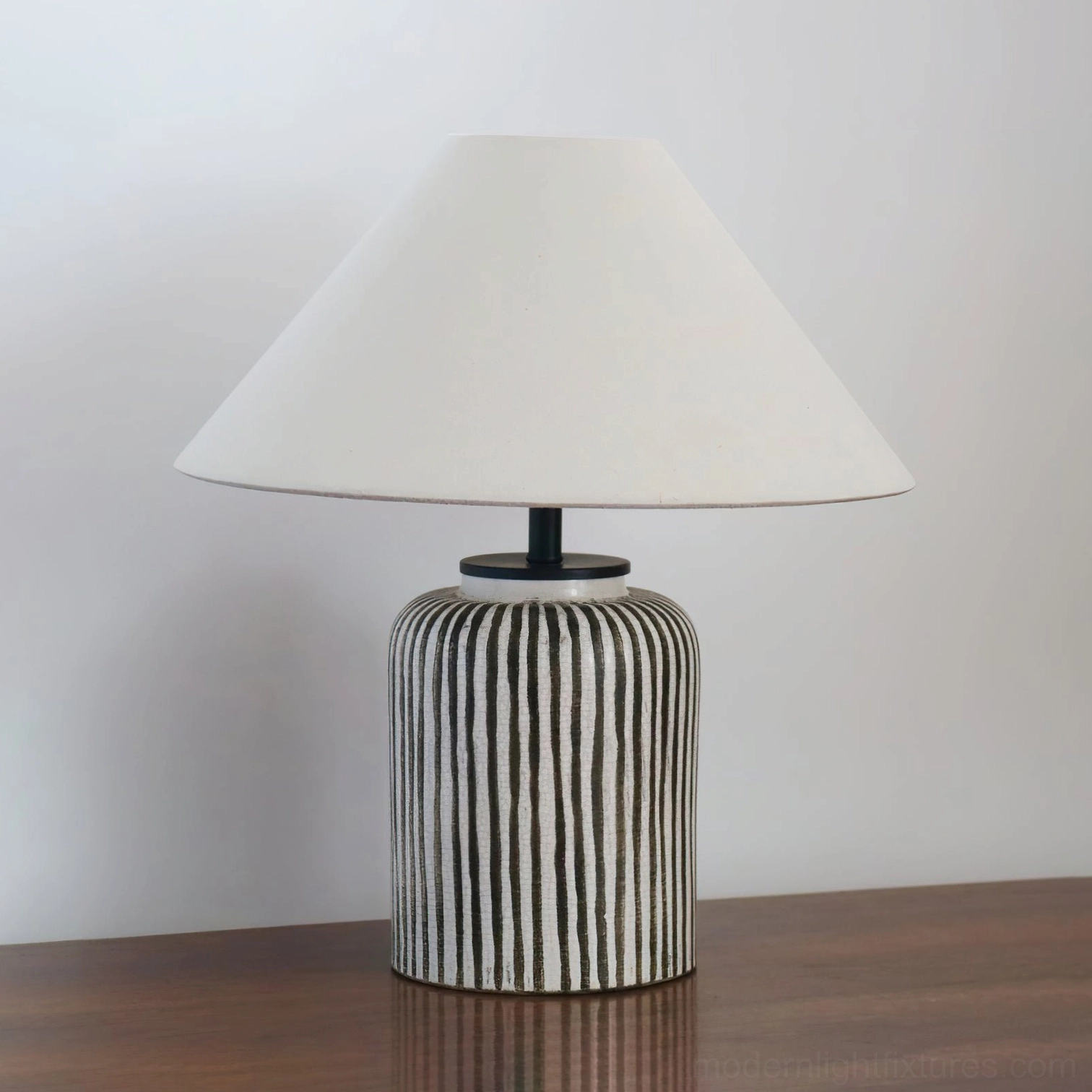 Striped ceramic table lamp in Scandinavian minimalist interior with neutral color palette