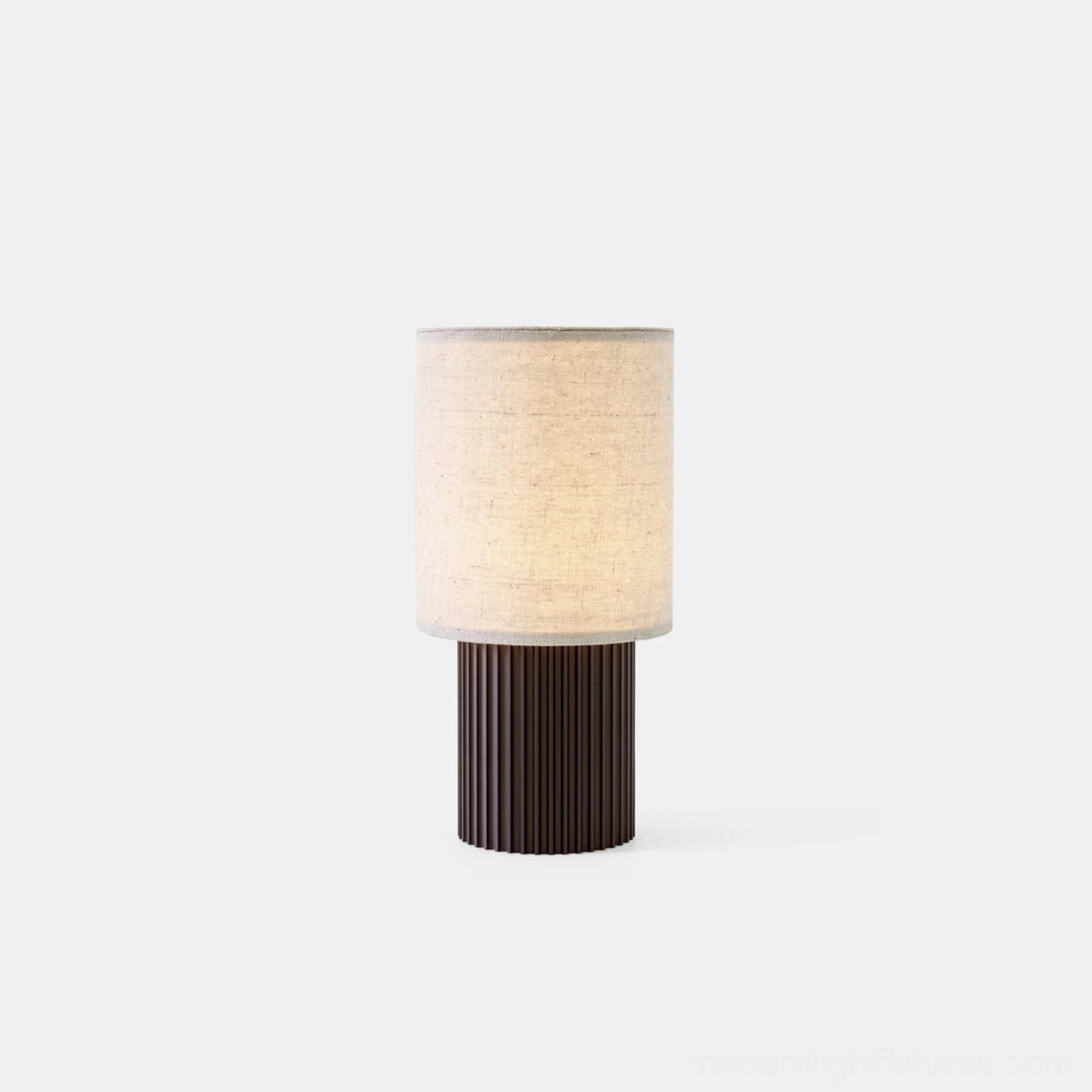 Scandinavian minimalist table lamp with fluted metal base and natural fabric shade, front studio photography showcasing contemporary design