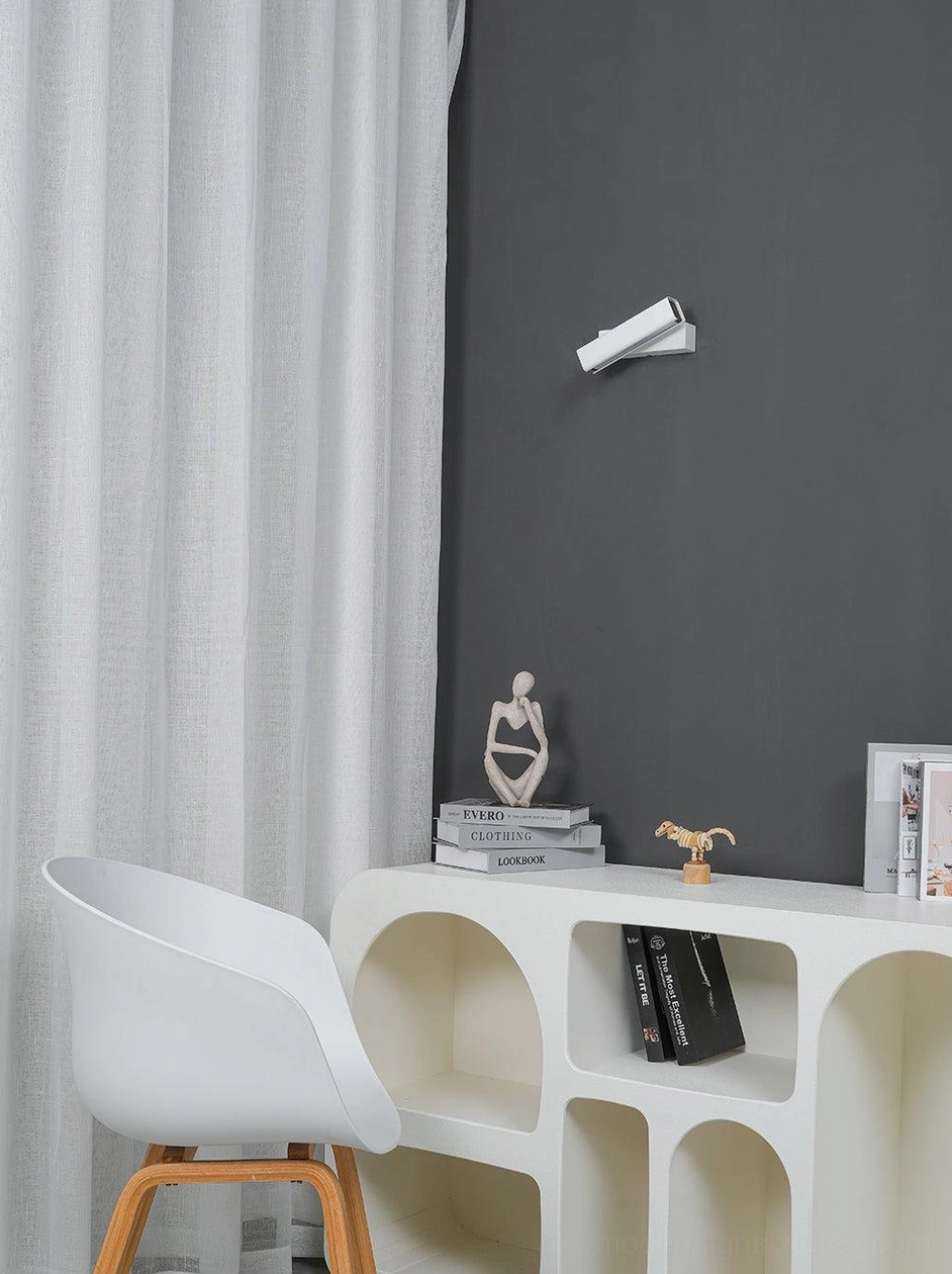 Scandinavian wall lamp with matte finish mounted on textured wall, showcasing Nordic design aesthetic