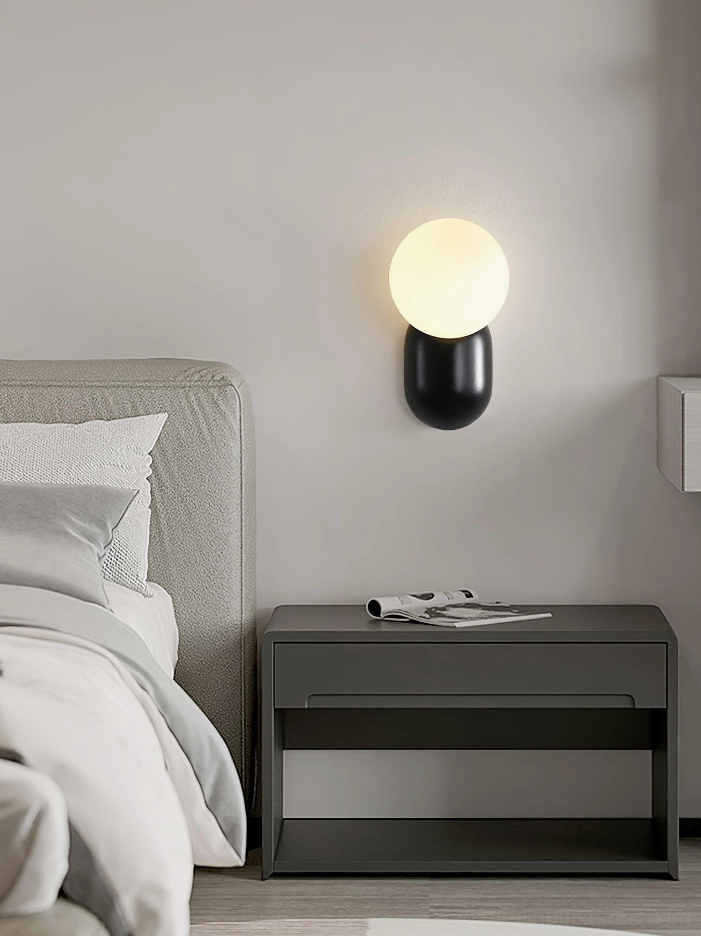 Spherical wall sconce paired with Scandinavian minimalist interior design and natural wood elements