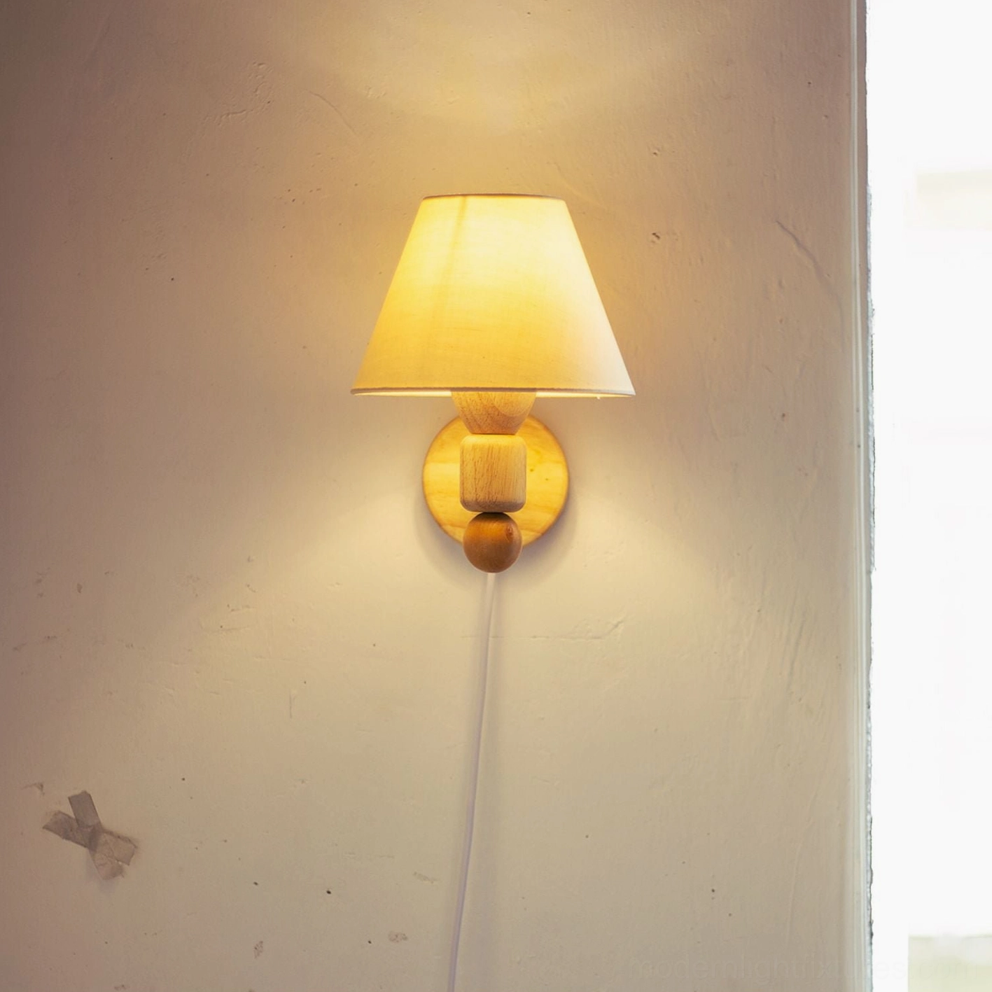 Modern minimalist wall sconce in natural wood with beige fabric shade showcasing Scandinavian design aesthetic
