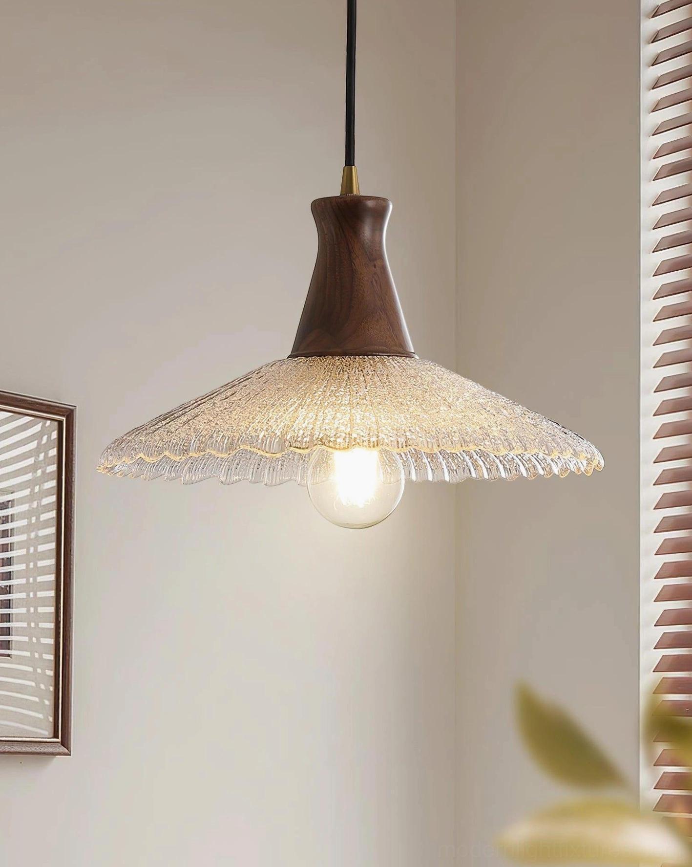 Minimalist walnut wood pendant lamp with ribbed clear glass demonstrating clean Scandinavian design lines