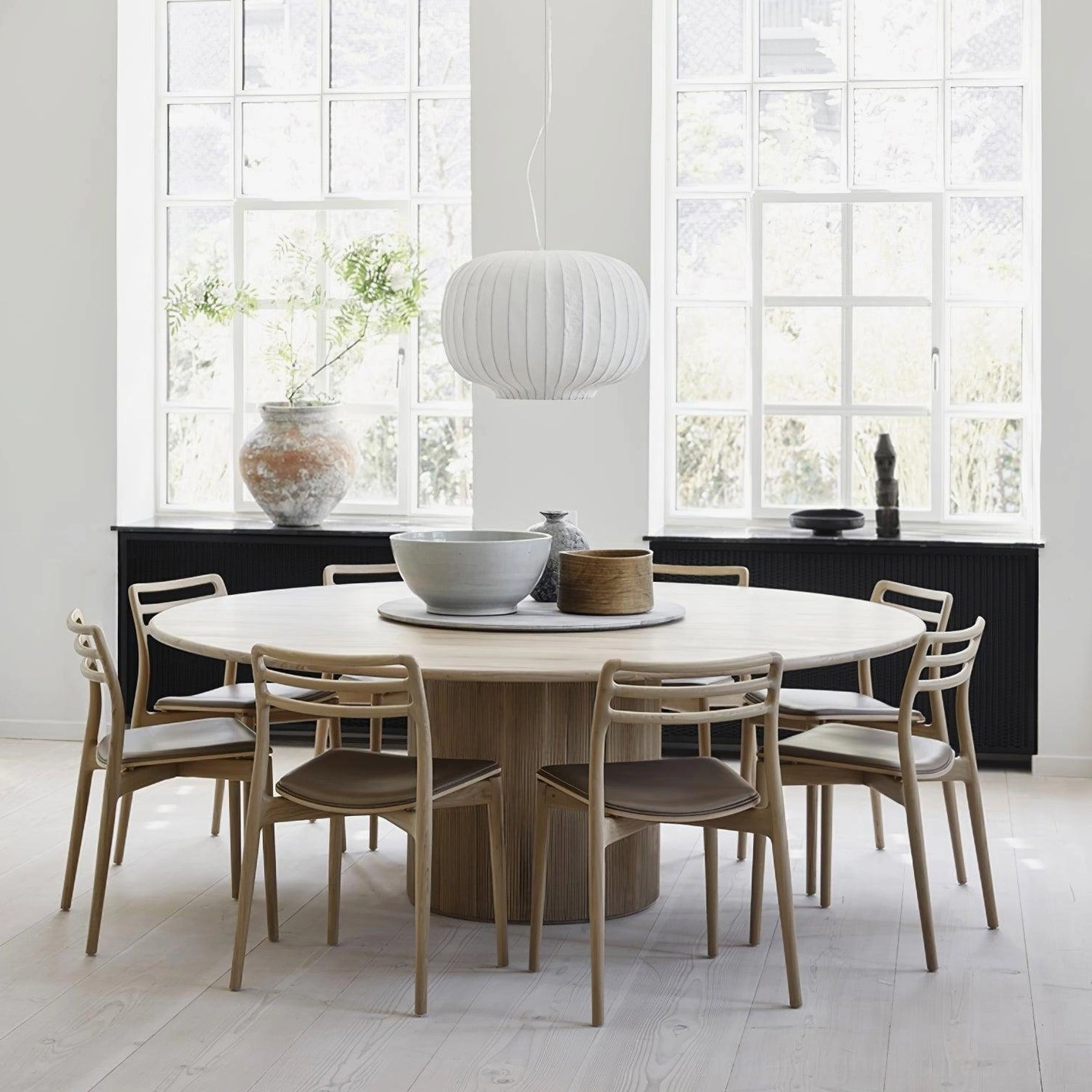 Single modern oval fabric pendant light in Nordic style dining room with natural window lighting