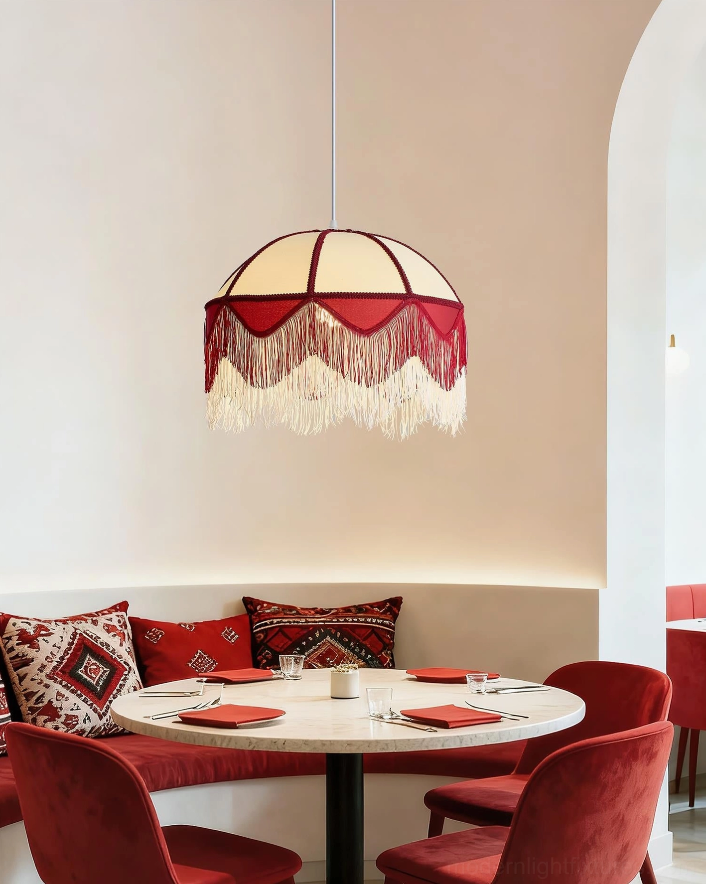 Fringed Pendant Lamp in café restaurant booth with red seating and bohemian atmosphere