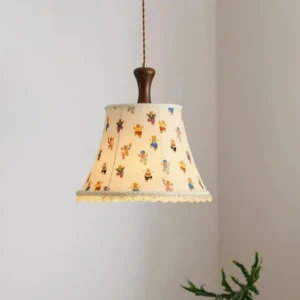 Colorful striped fabric pendant lamp with lace trim in modern interior with green plant decor and warm ambient lighting